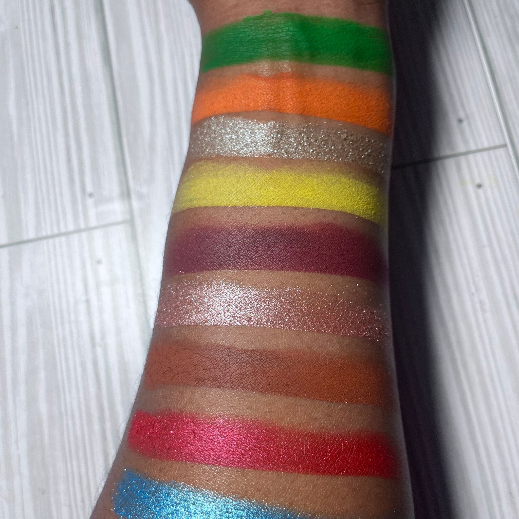 Side view of On the Rocks eyeshadow palette showing rich mineral shades in rectangular pans with sleek black packaging