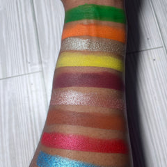 Side view of On the Rocks eyeshadow palette showing rich mineral shades in rectangular pans with sleek black packaging