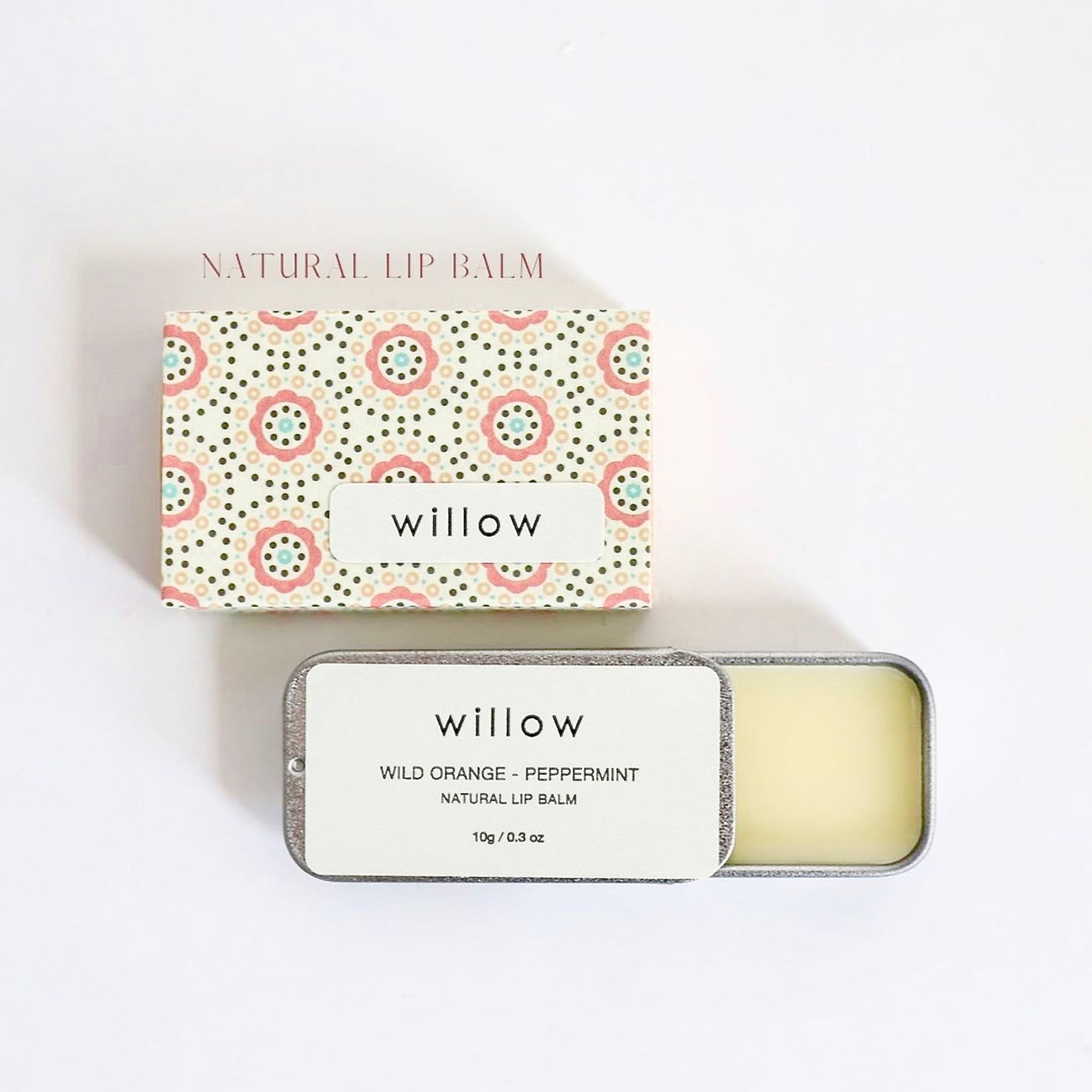 Lip balm in floral patterned box and metal tin, with "willow" text visible
