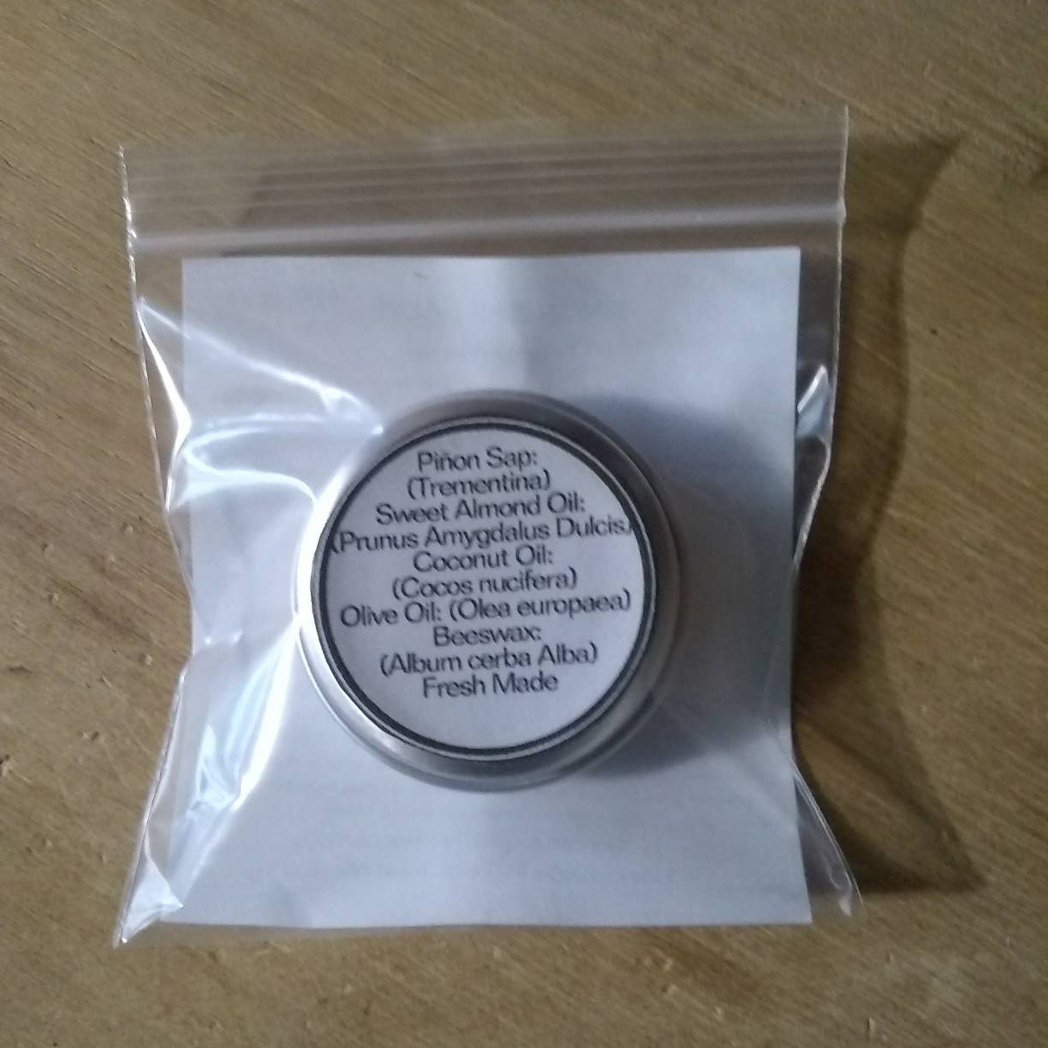 Pion Sap tin in clear plastic bag, with white label, and silver metal container.