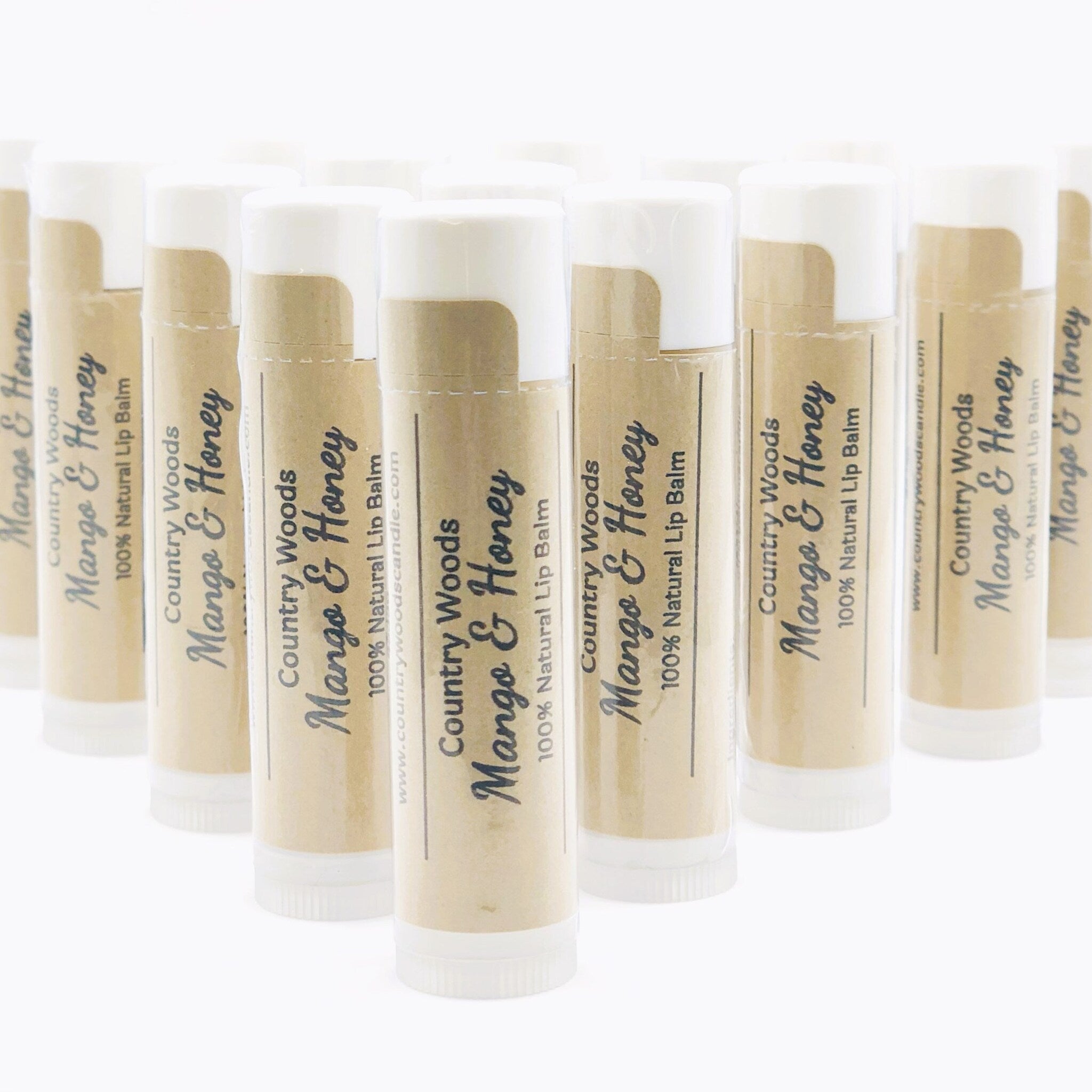 Lip balm tubes with white and tan packaging, Country Woods Mango & Honey label visible