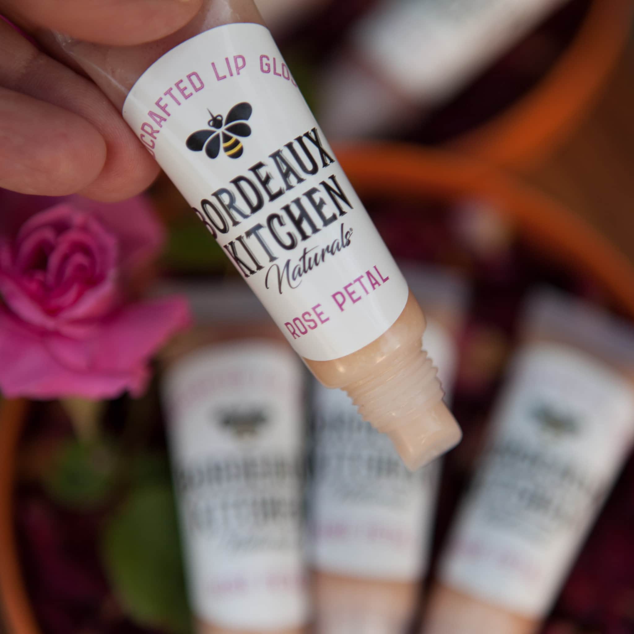 Lip gloss tube with clear plastic, beige gloss, and Bordeaux Kitchen label