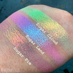 Close-up of multichrome eyeshadow palette showing vibrant shifting hues from pink to gold to green