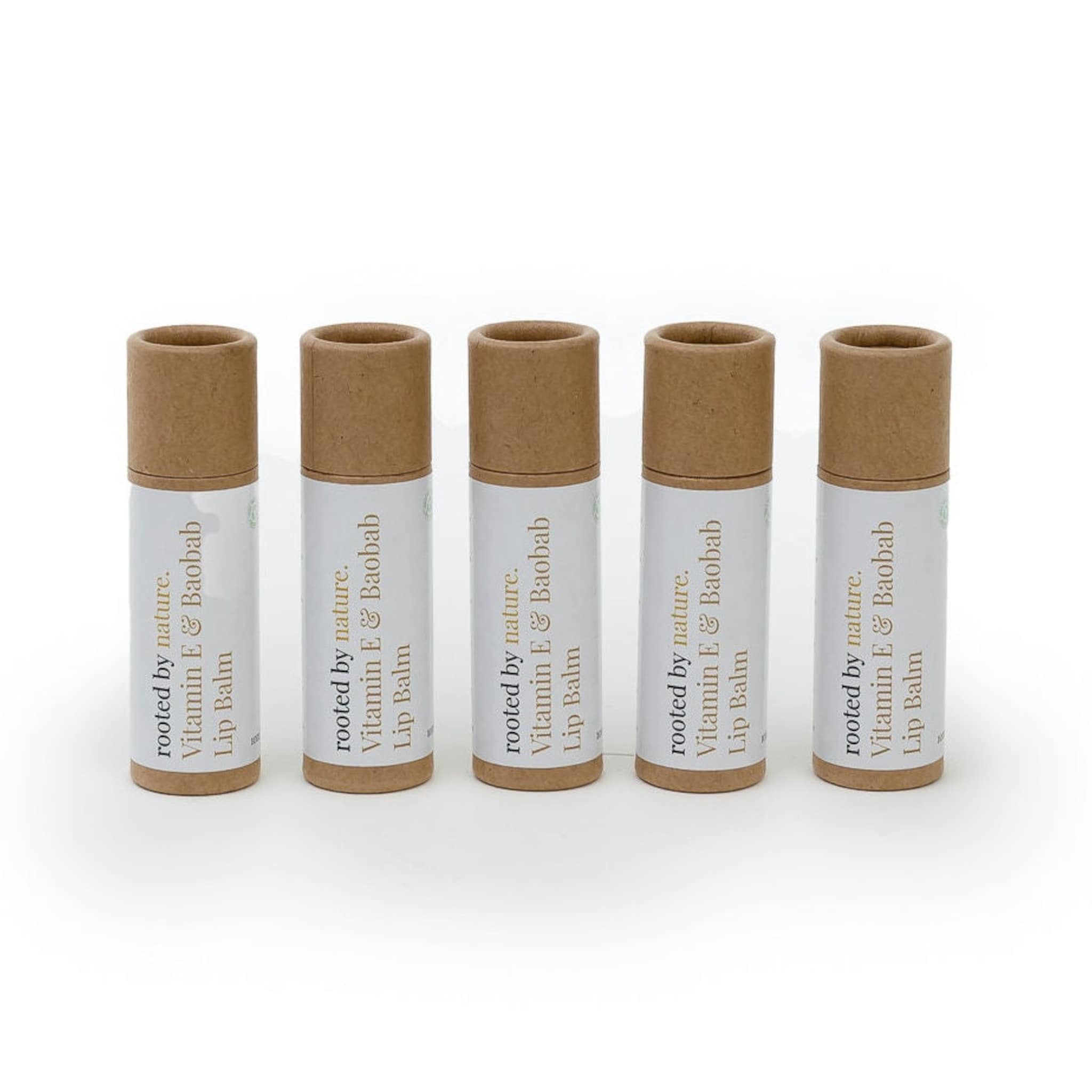 Lip balm tubes with brown and white labels, natural cardboard tops, and "rooted by nature" text.