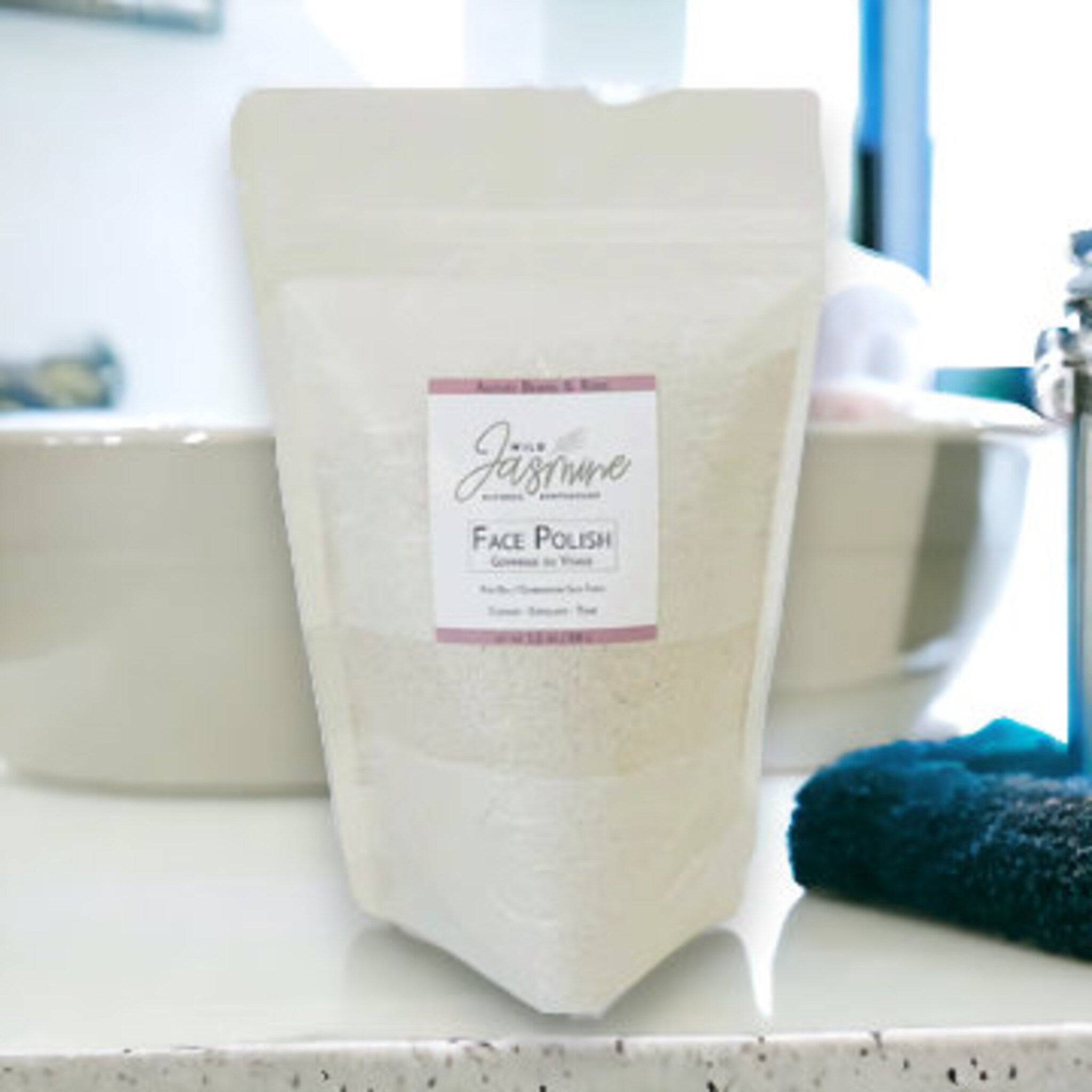 Face Polish refill in clear plastic pouch with Wild Jasmine label, on counter