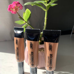 Face makeup concealer tubes in beige and black with Black Radiance text visible