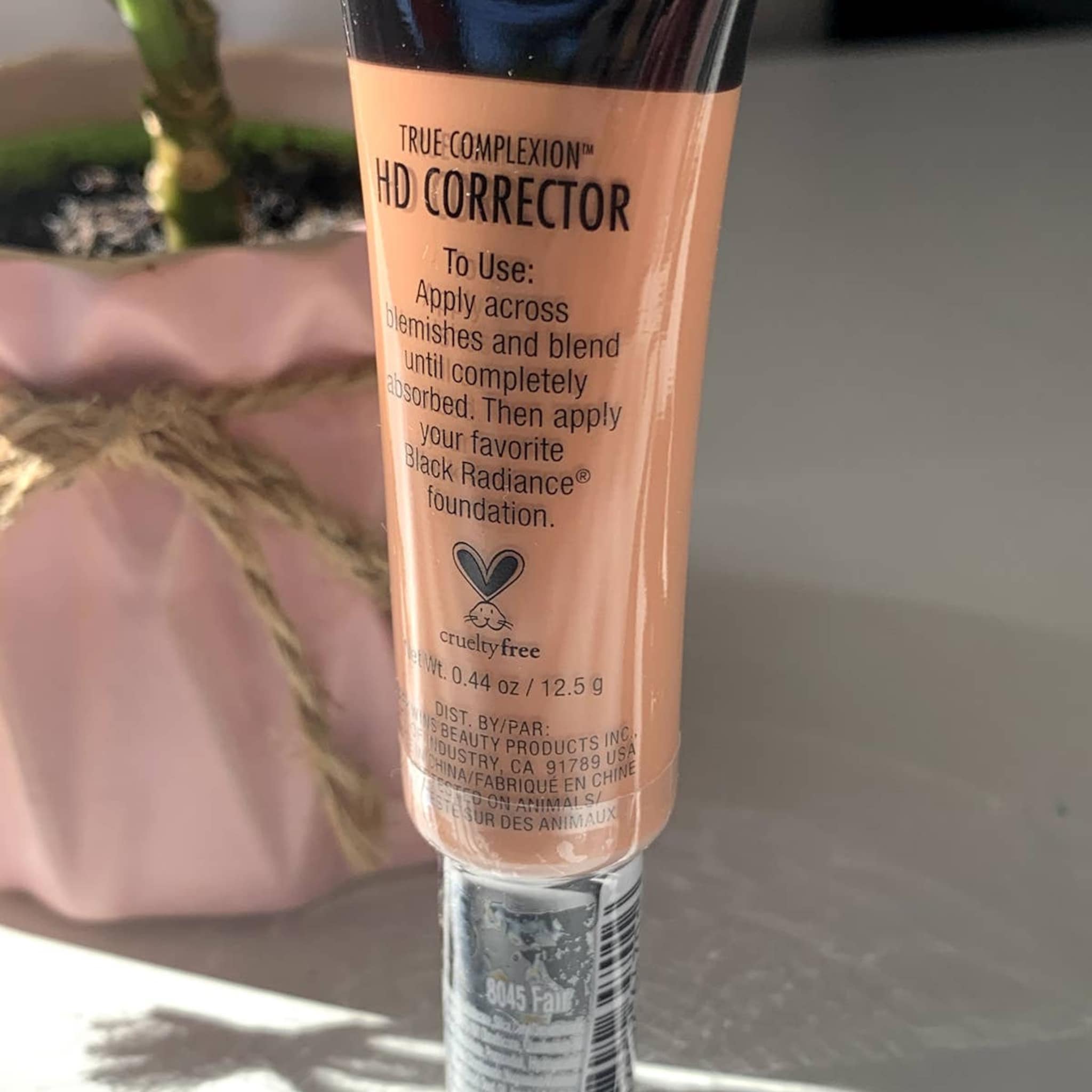 HD corrector tube in peach color with black text, "Black Radiance" visible