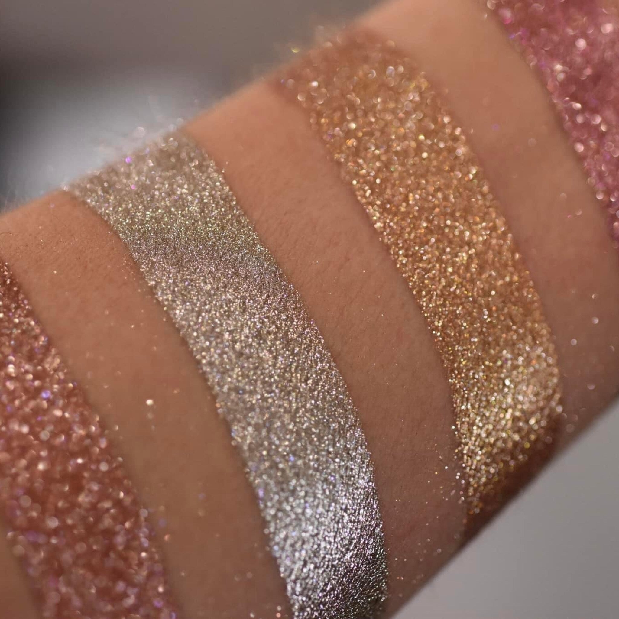 Close-up of Molten Shadow Diamond Luxe eyeshadow palette with shimmering metallic shades in gold and bronze tones