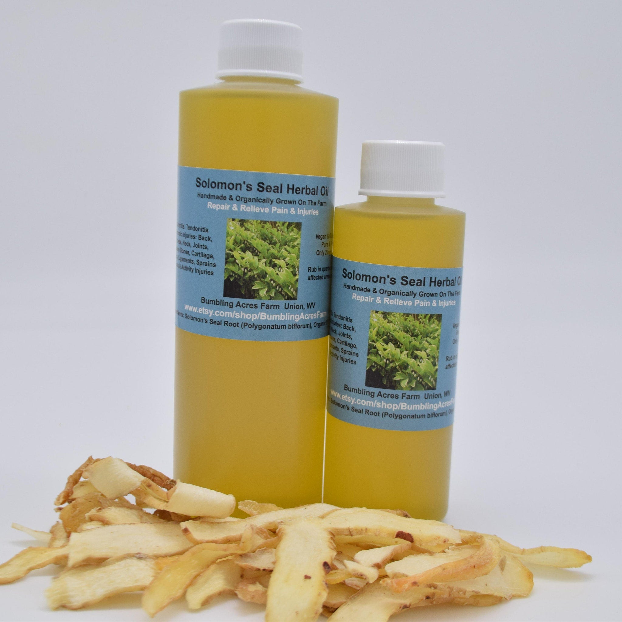 Herbal oil bottles with yellow liquid, white caps, and Solomon's Seal label, with dried root pieces