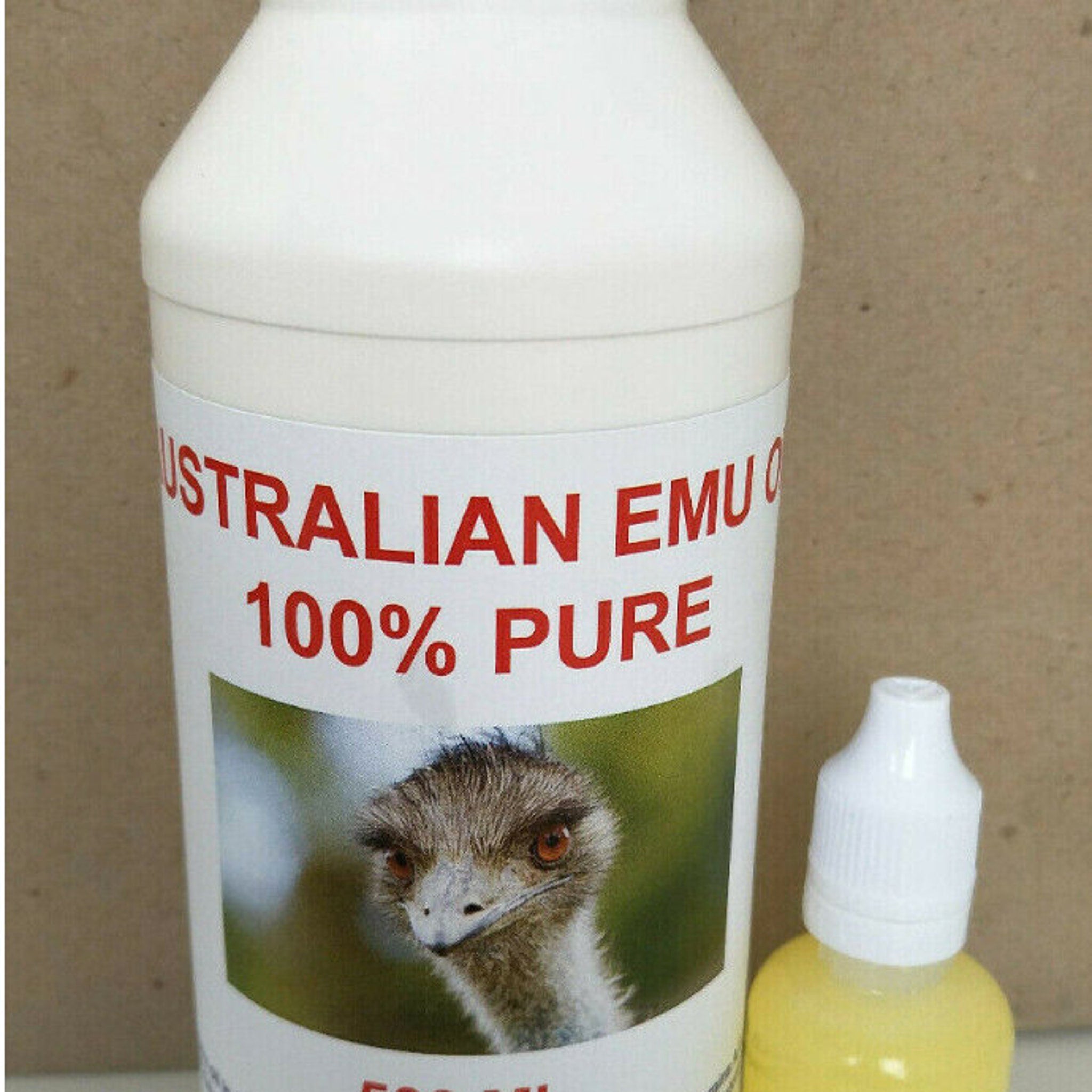 Golden emu oil being gently massaged into clean skin with fingertips for deep hydration