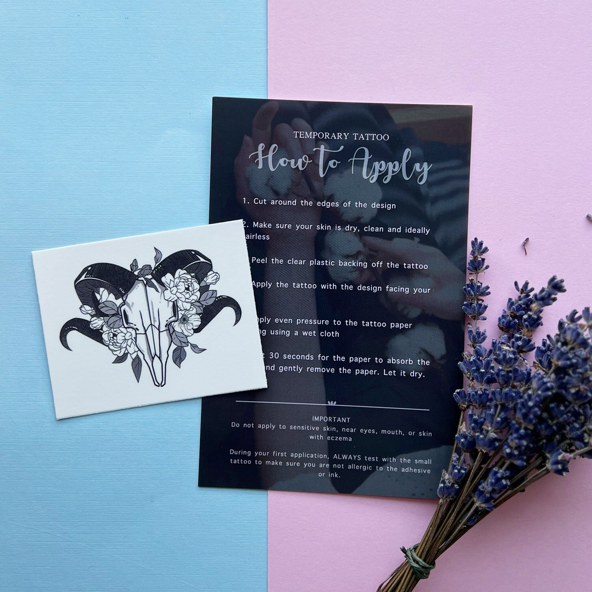 Temporary tattoo with black and white ram skull design on white paper, with instructions card