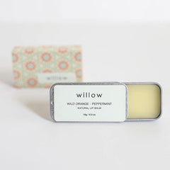 Lip balm tin with silver metal, white label with "willow" text, and yellow balm inside