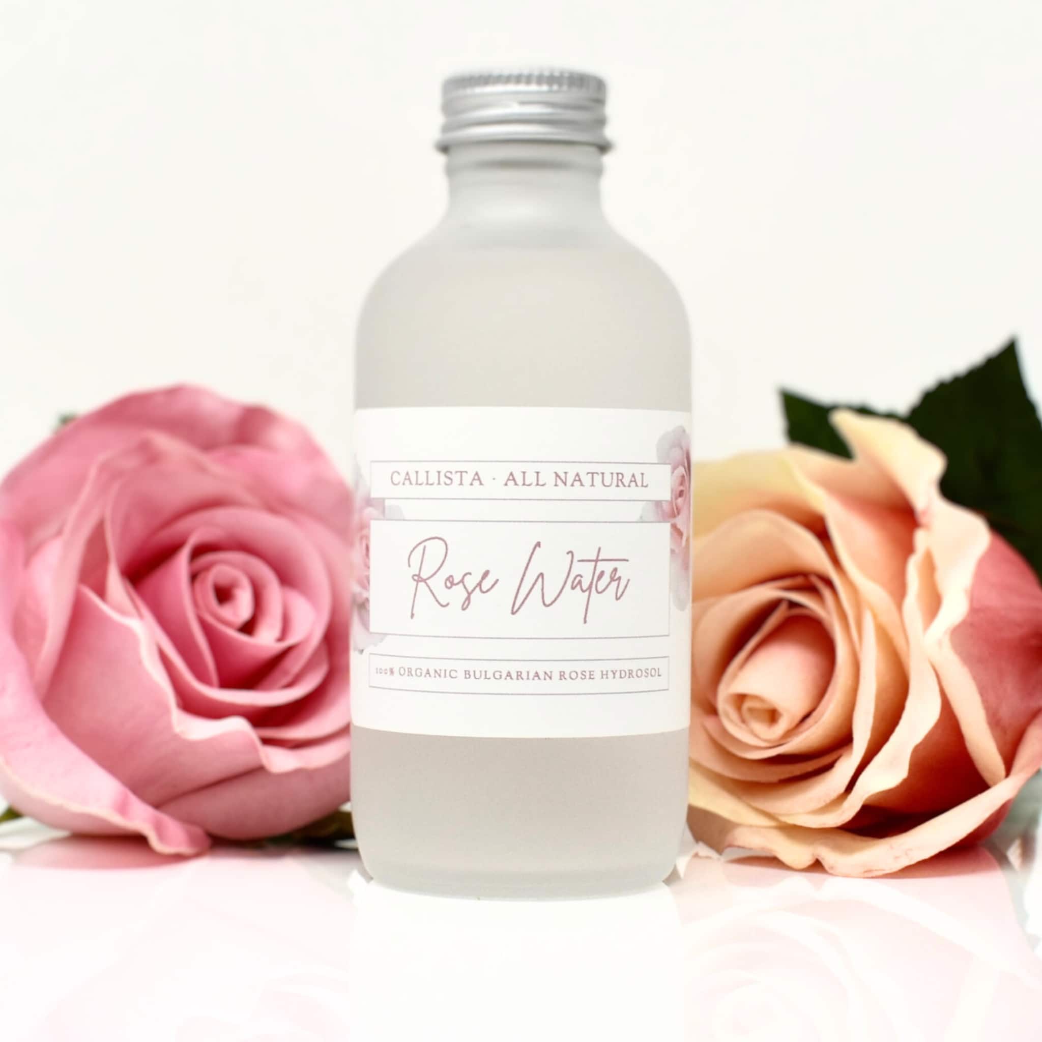 Rose water bottle with frosted glass, silver cap, and Callista label with pink roses
