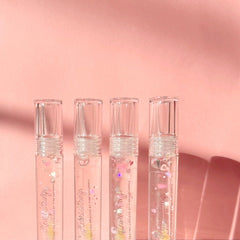 Lip gloss tubes with clear plastic, pink liquid, and glitter, labeled Heart Strings by Pinkishpurple