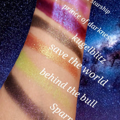 Side view of vegan trichrome eyeshadow palette showing chameleon color shift from green to purple with shimmer glitter particles