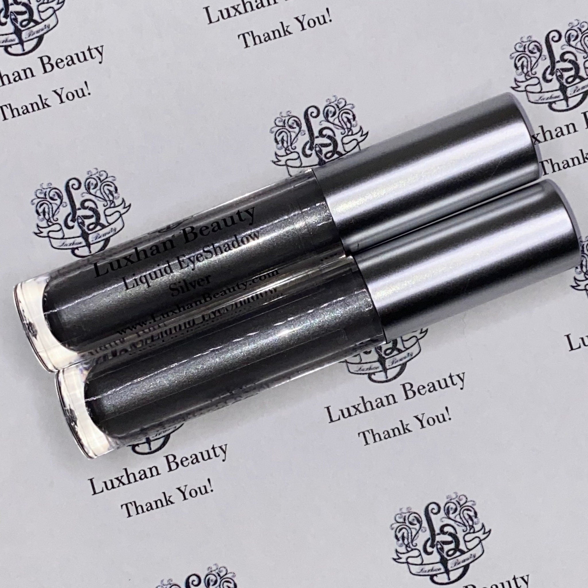 Close-up of silver glitter liquid eyeshadow with metallic sheen, showing shimmer texture in bright light