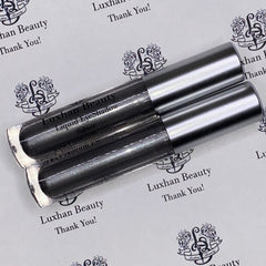 Close-up of silver glitter liquid eyeshadow with metallic sheen, showing shimmer texture in bright light