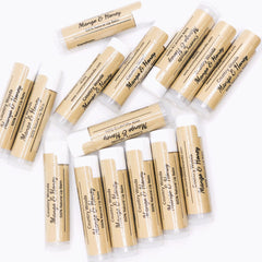 Lip balm tubes, tan paper, white caps, Country Woods brand name visible