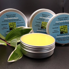 Organic salve in metal tin with yellow contents and Bumbling Acres Farm label