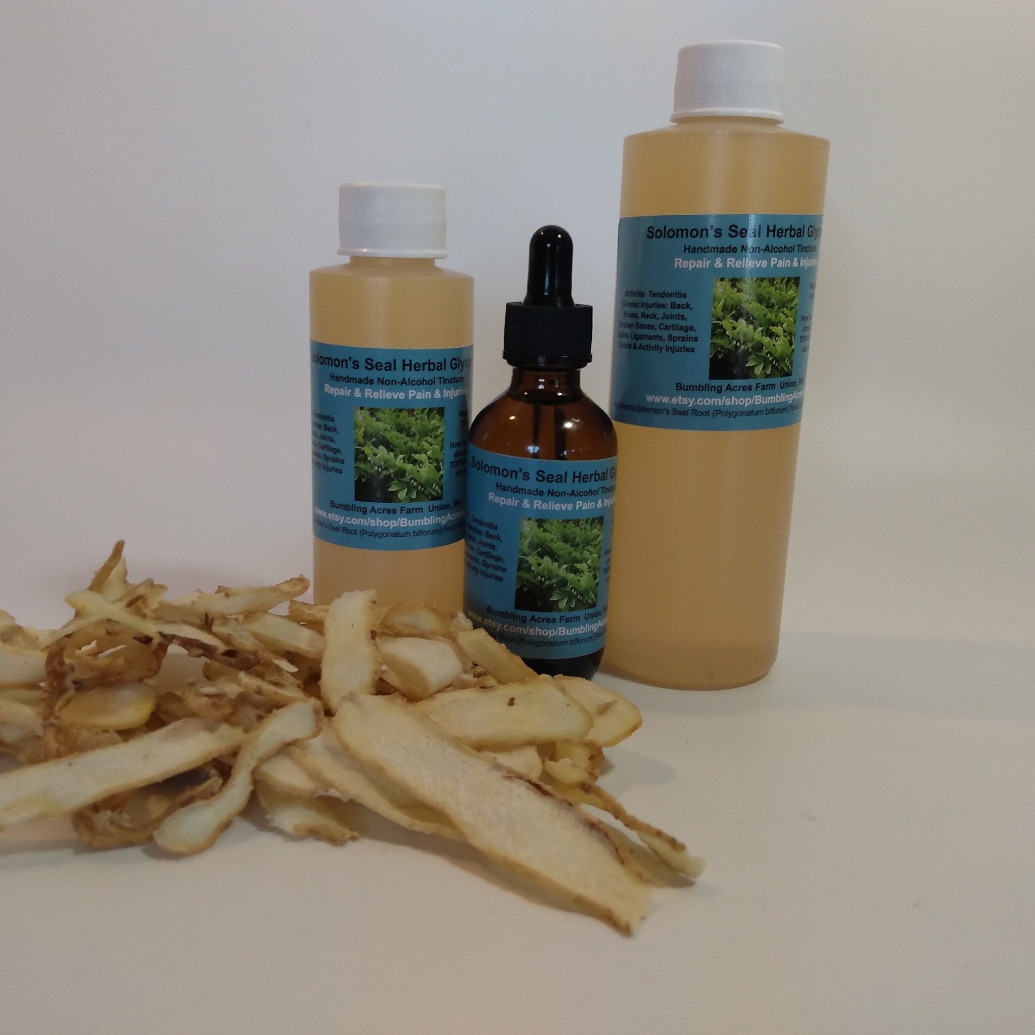 Herbal tincture bottles with brown glass, white caps, and Solomon's Seal label and dried root pieces