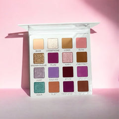 Open lilac eyeshadow palette with six matte and shimmer shades in purple tones, displayed on white background