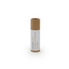 Lip balm tube with brown and white paper packaging, vertical text, and natural material