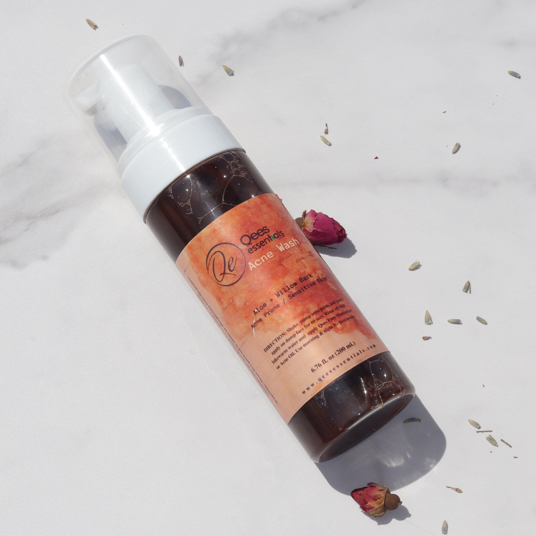 Dark brown African black soap cleanser in a sleek plastic bottle with white pump dispenser for oily skin