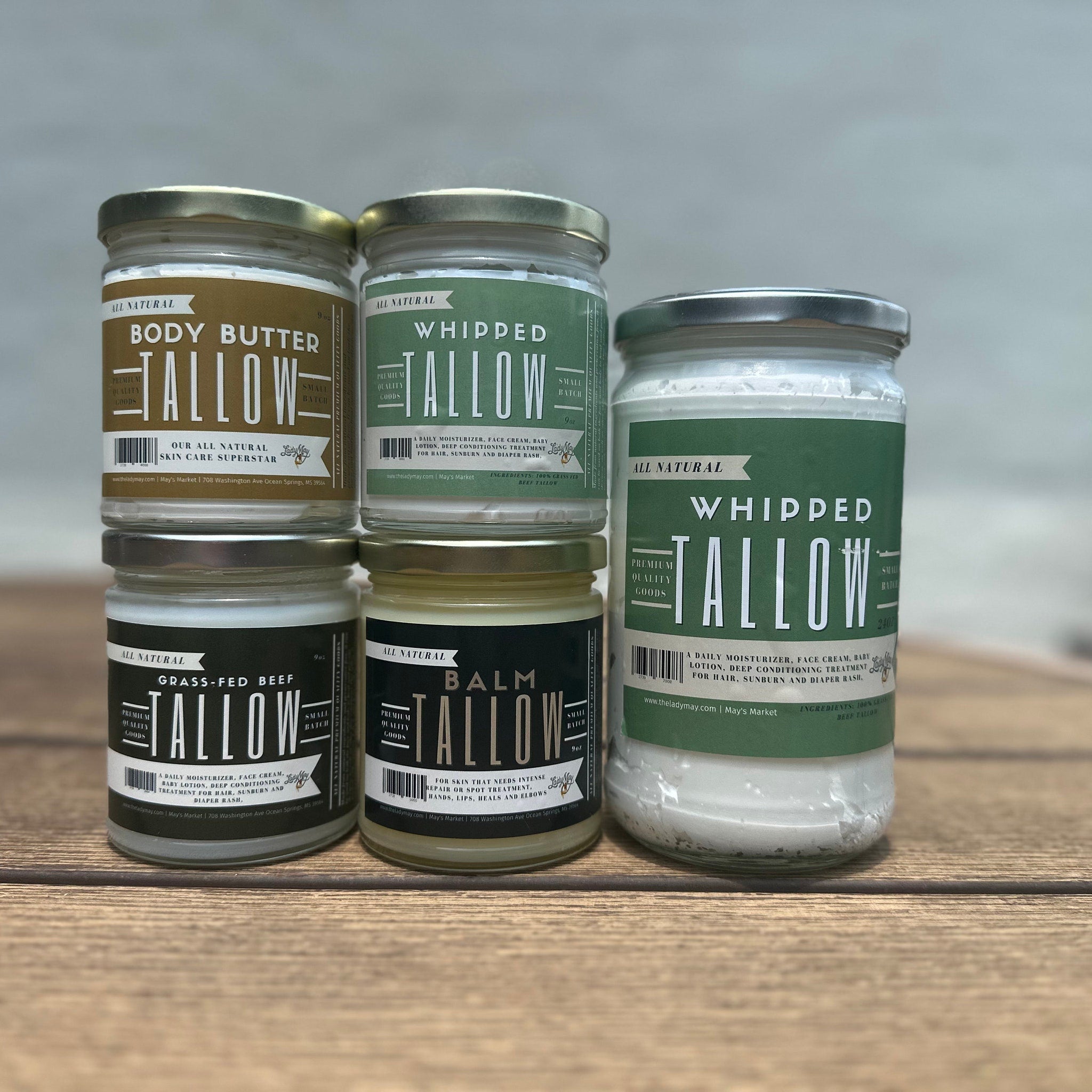 Tallow skincare products in glass jars with white, green, and brown labels, Lady May brand visible