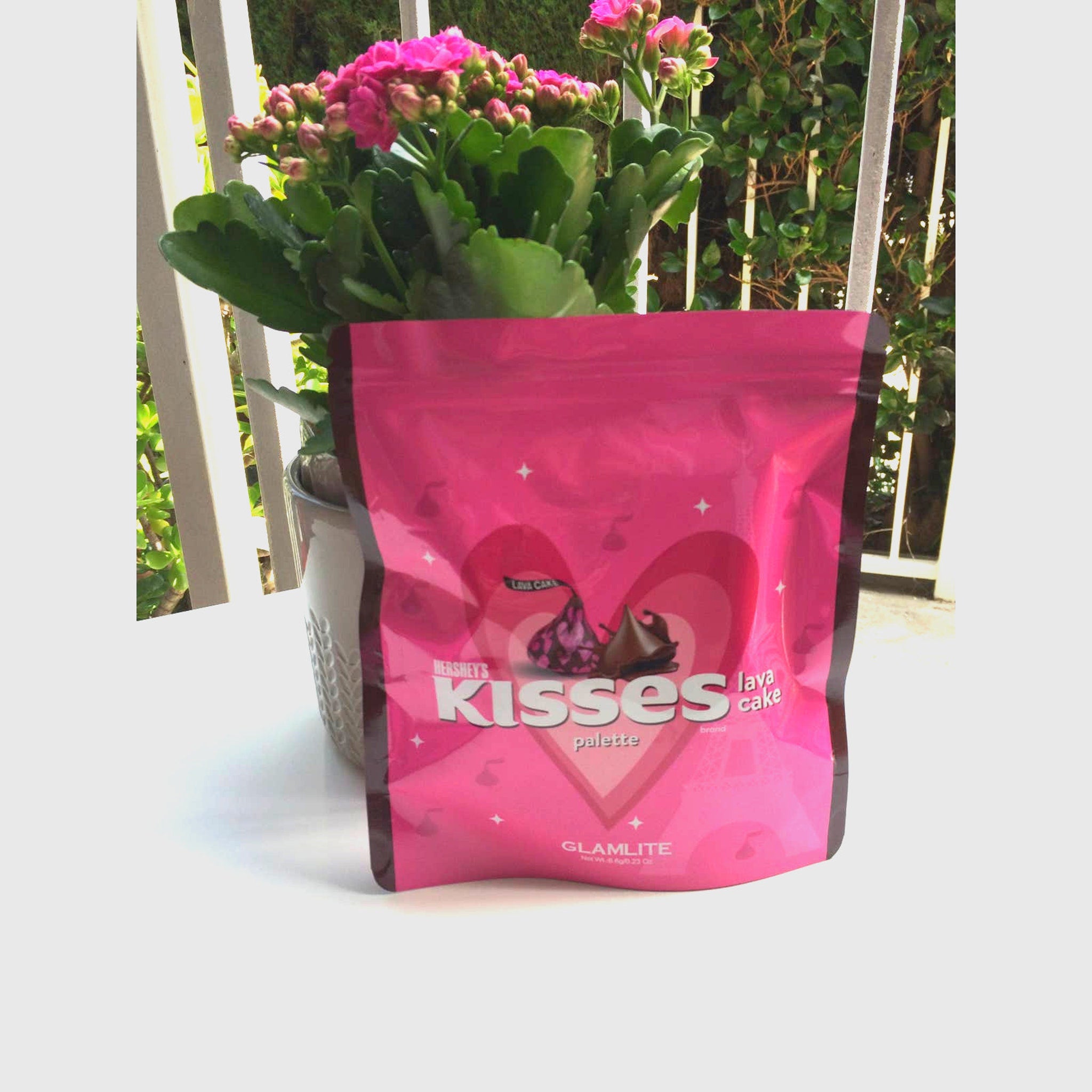 Eye makeup palette pink Hershey's KISSES x GLAMLITE packaging with heart design and brand name visible