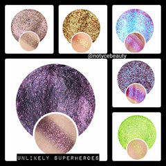 Close-up of trichrome eyeshadow pan showing vibrant color shift from teal to purple with shimmer particles.