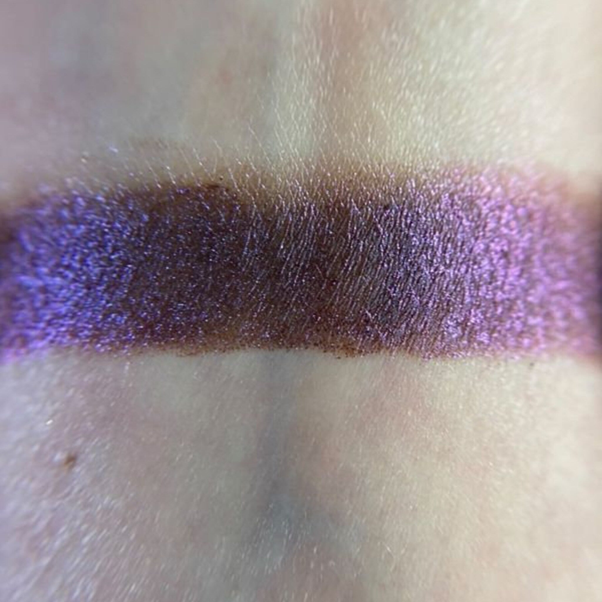 Close-up of Embers Eye Shadow pan showing rich bronze shimmer with smooth satin finish