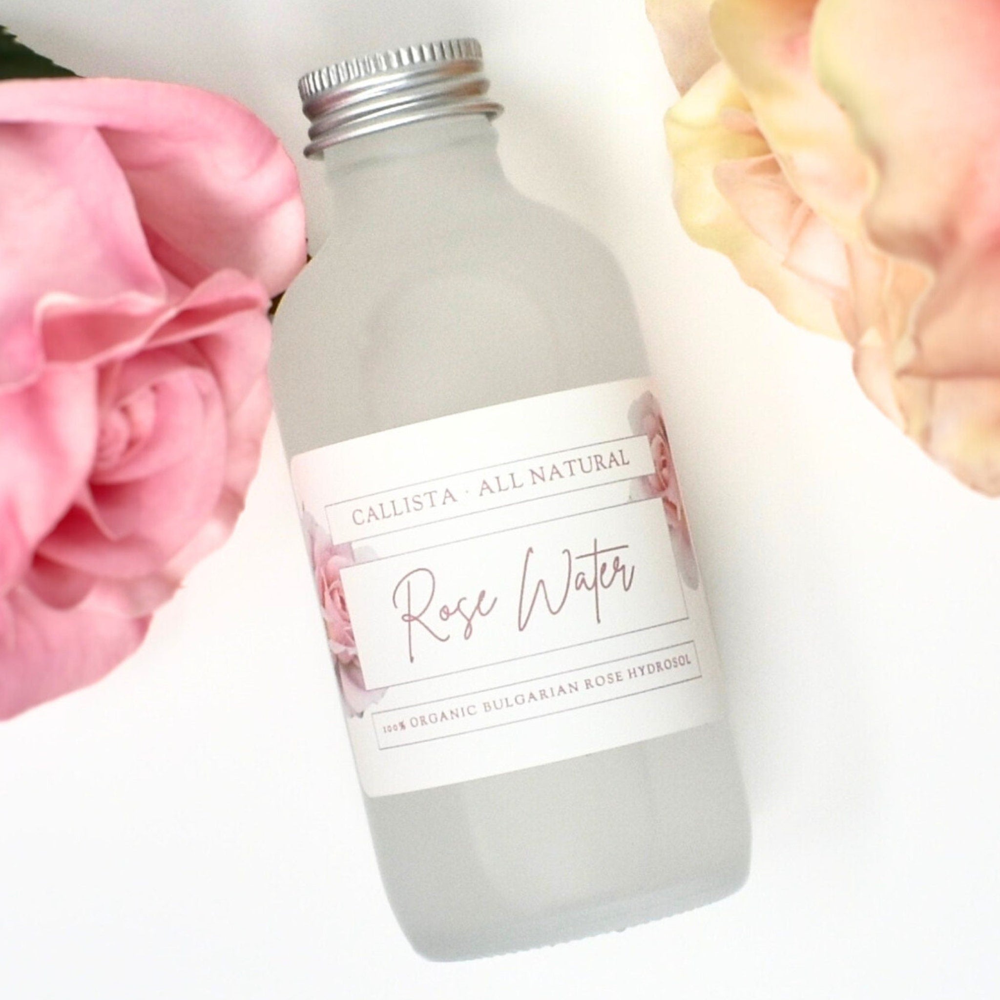 Rose water bottle with frosted glass, silver cap, and Callista label with rose accents