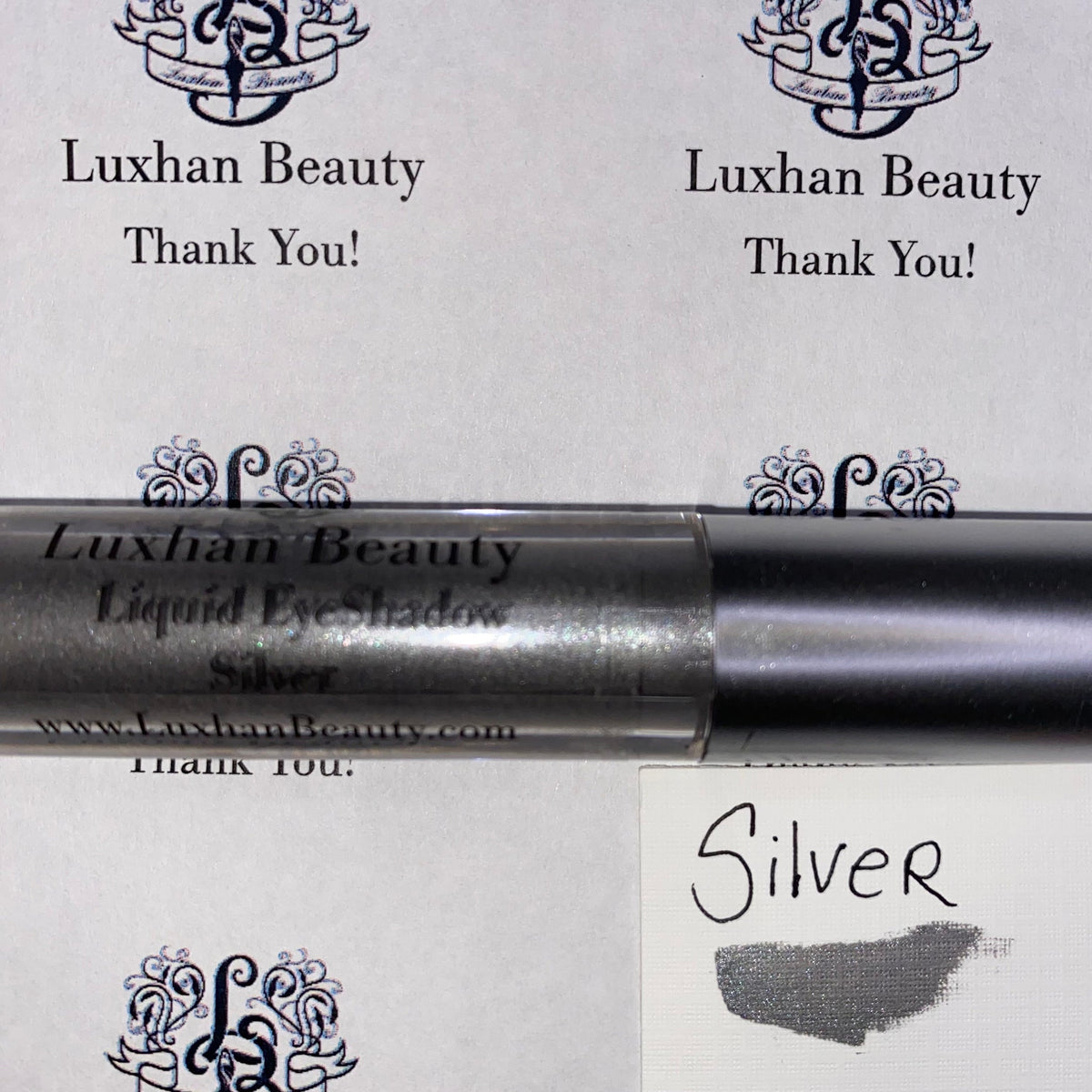 Silver glitter liquid eyeshadow in sleek tube with doe-foot applicator, shimmering metallic finish