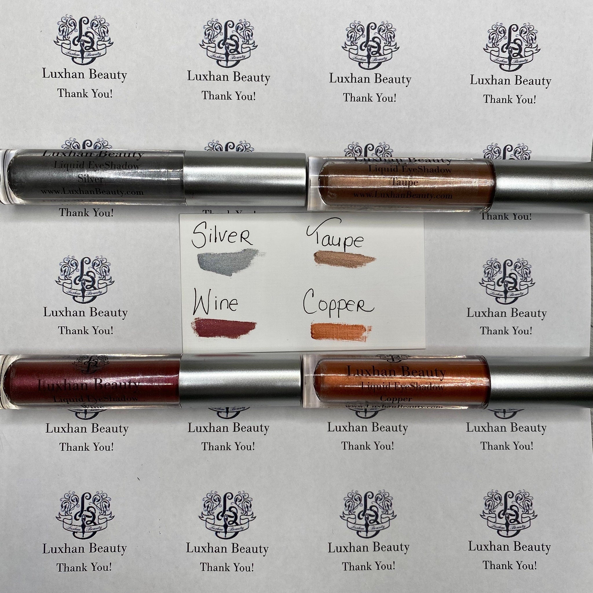 Silver glitter liquid eyeshadow swatched on hand, showing intense metallic shimmer and smooth texture