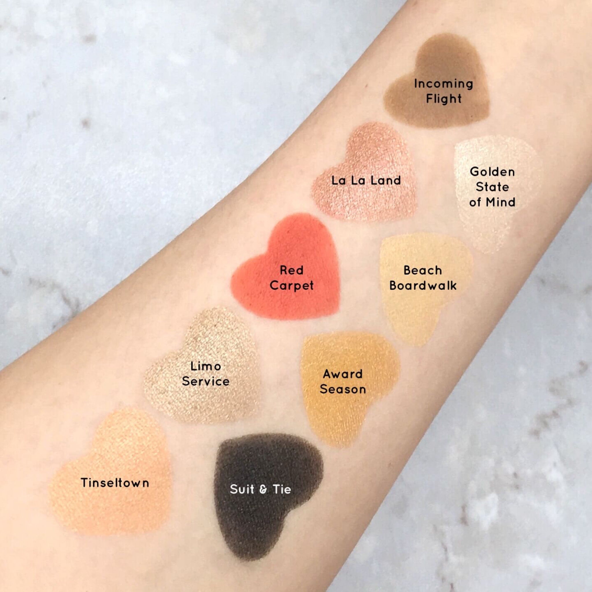 Eyeshadow swatches in various colors and textures, including red, gold, and brown, Mavie Cosmetics