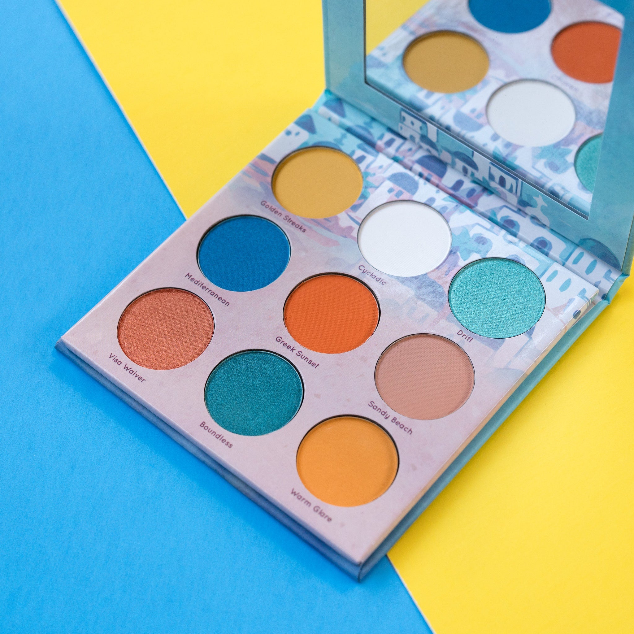 Eyeshadow palette with multiple colors, round pans, and a mirror for Mavie. Cosmetics