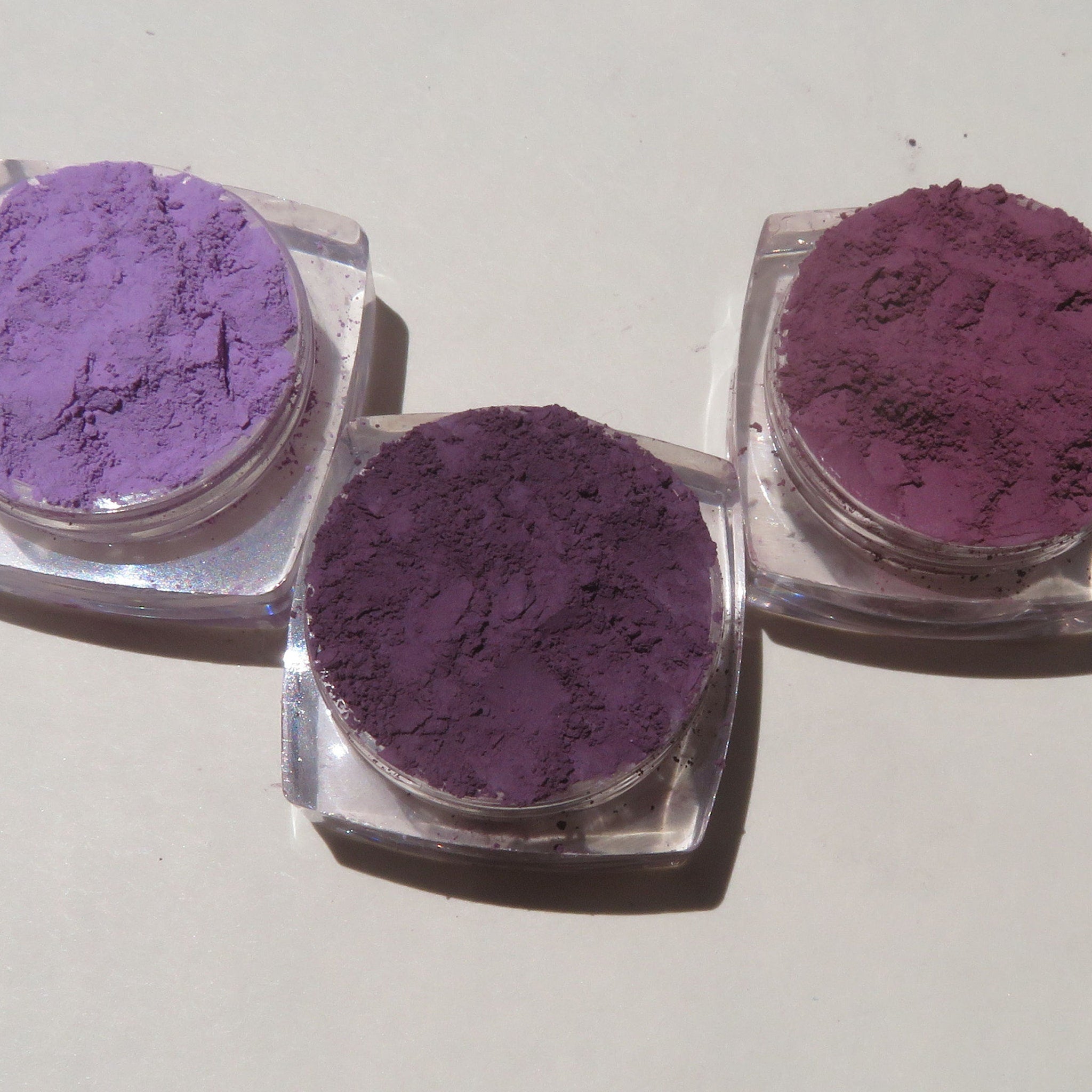 Close-up of matte purple loose mineral eyeshadow with fine powder texture in vegan, cruelty-free gift set
