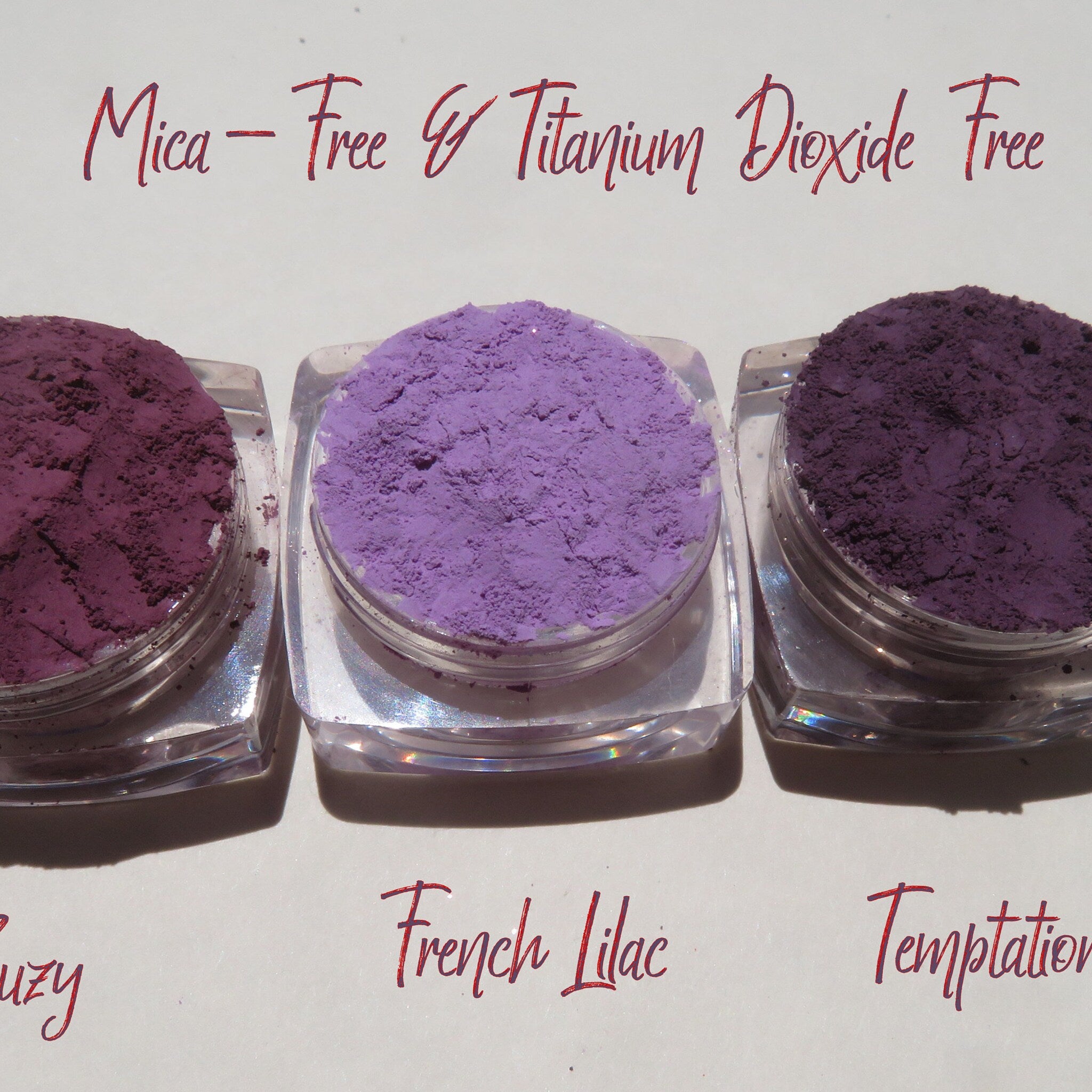 Side view of matte purple mineral eyeshadow set showing loose powder texture in vegan-friendly packaging