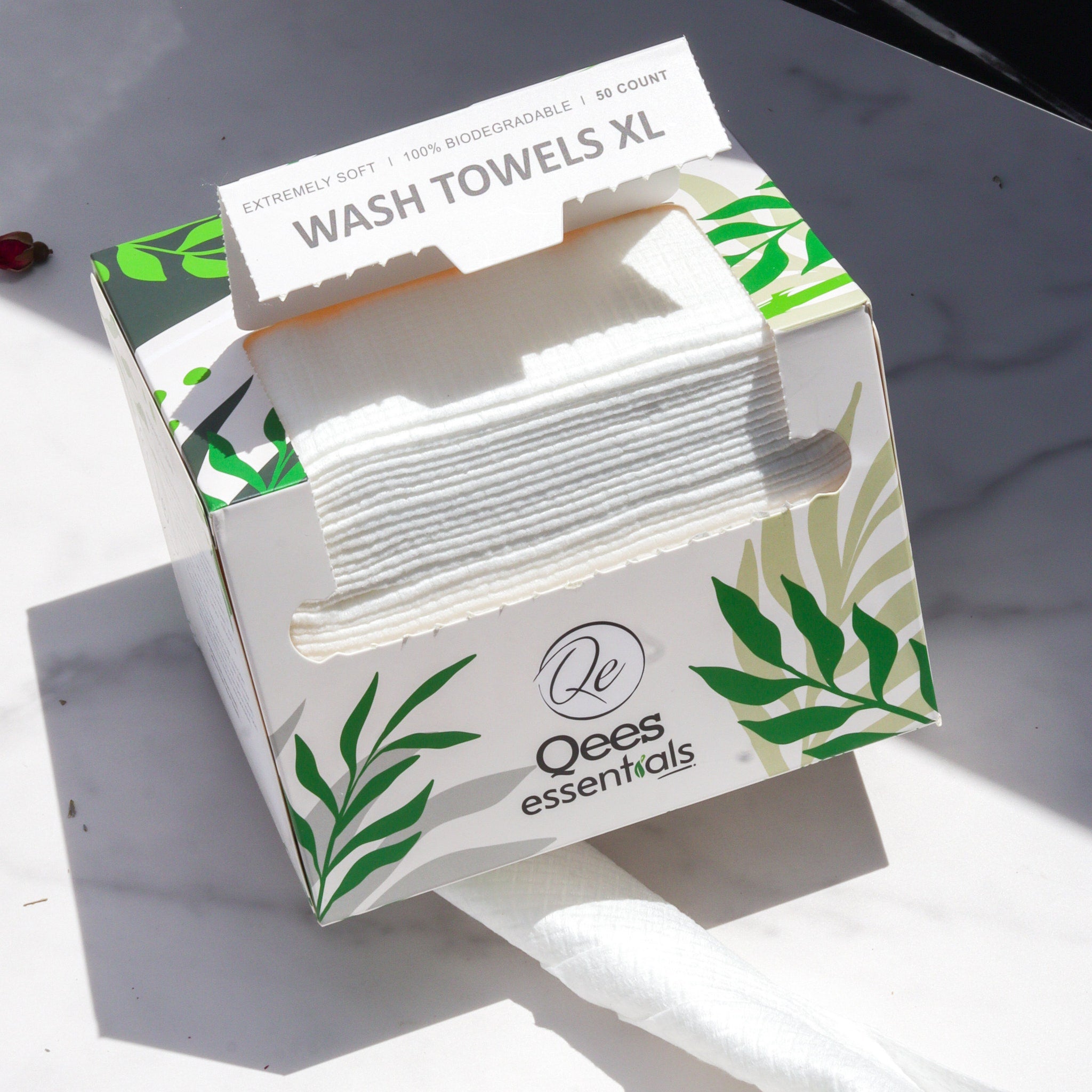 Wash towels XL white rectangular box with green leaf design, "Qees essentials" branding visible