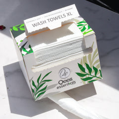 Wash towels XL white rectangular box with green leaf design, "Qees essentials" branding visible