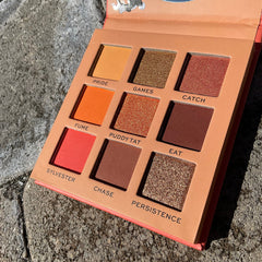 Side view of I Heart Revolution Sylvester Looney Tunes eyeshadow palette showcasing 12 vibrant matte and shimmer shades