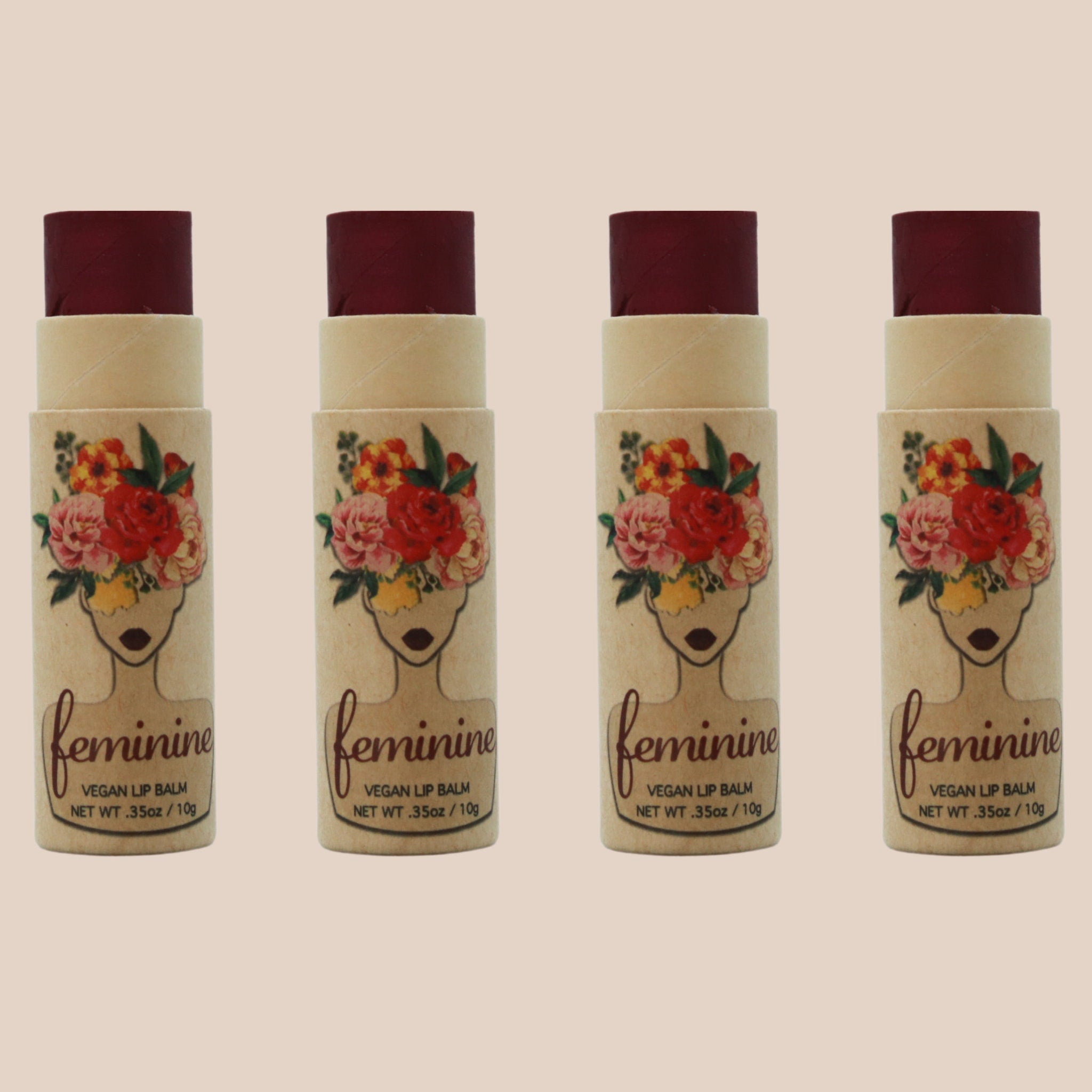 Lip balm tubes with burgundy balm, floral design, and "feminine" text on packaging