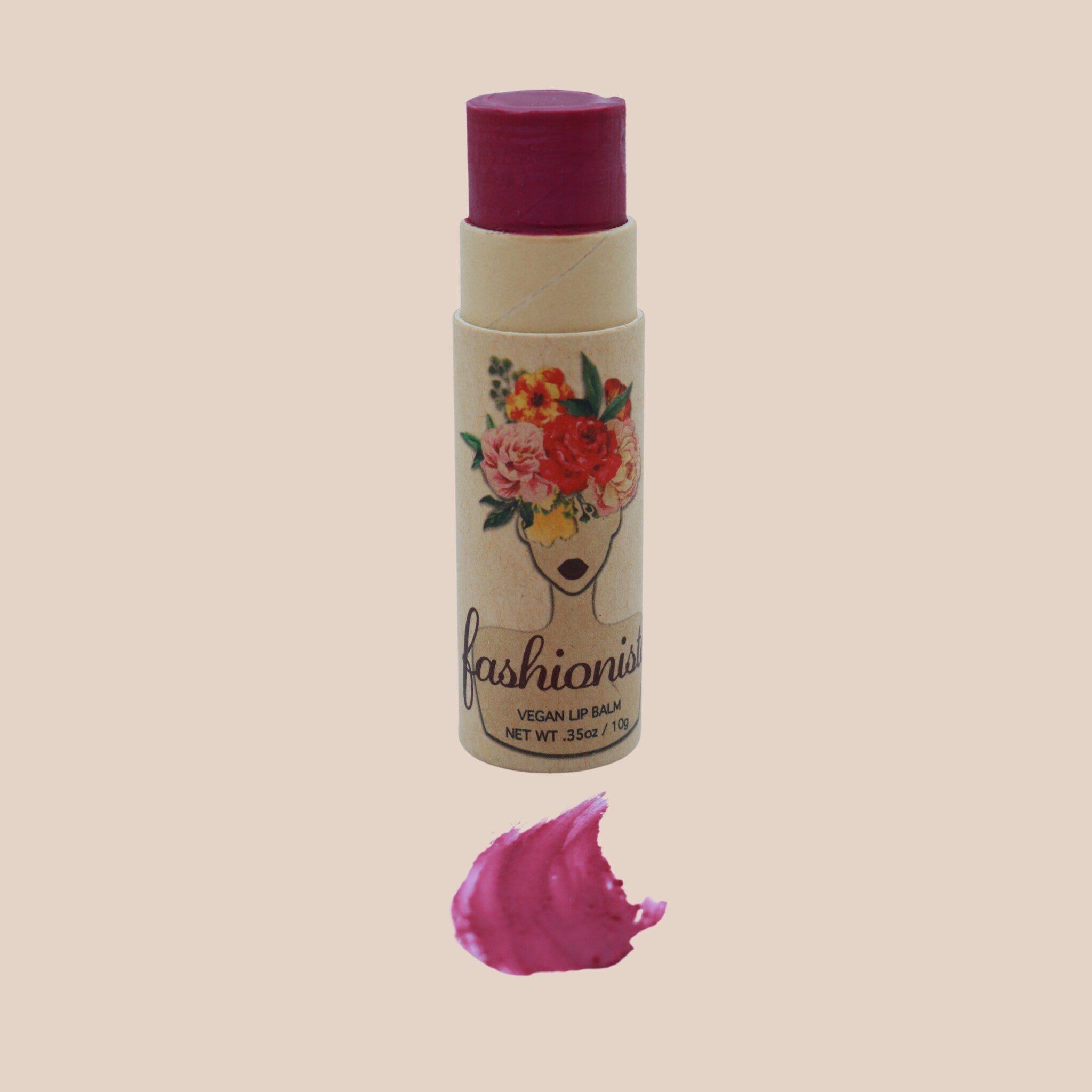 Lip balm with dark pink color, cardboard tube, and "fashionista" branding