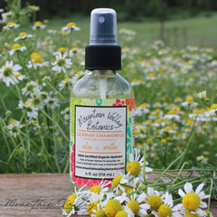 Toner spray bottle with black cap and Mountain Valley Botanics label, with chamomile flowers