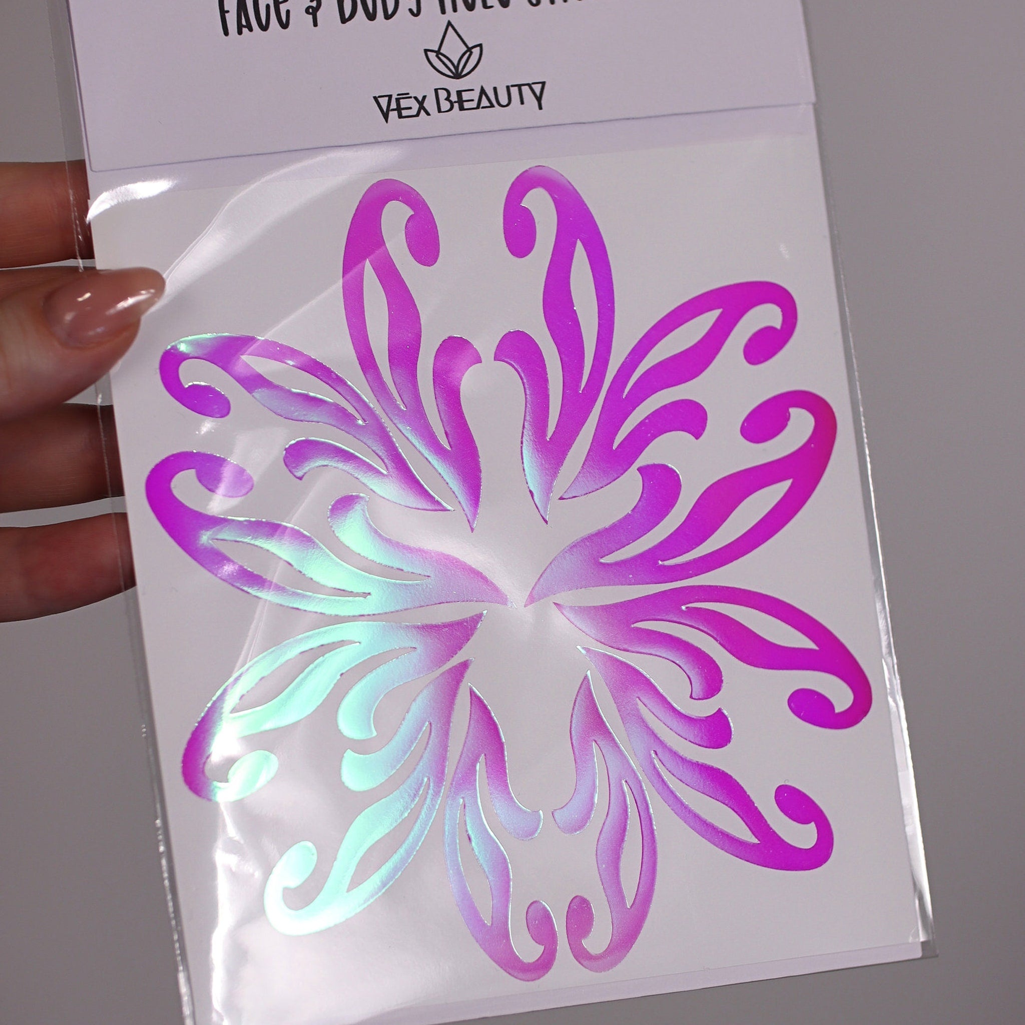 Face and body stickers with iridescent and magenta floral design, Vex Beauty brand