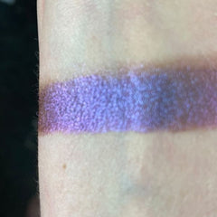 Close-up of Embers Eye Shadow in a warm copper shade with shimmer finish, displayed in a round compact.