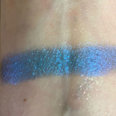 Close-up of shimmery bronze and taupe eye shadow pans with smooth, blendable texture in sleek black palette