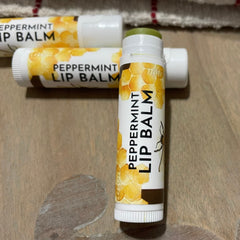 Peppermint lip balm tubes, white and brown with yellow honeycomb pattern, Sweet Honey Farm branding visible