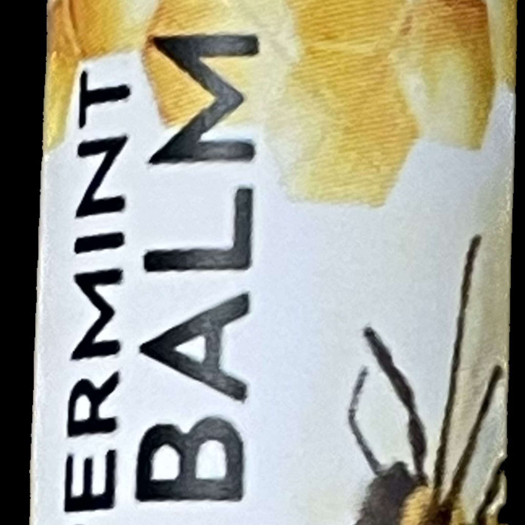 Balm label with black text on white, yellow background, and bee graphic