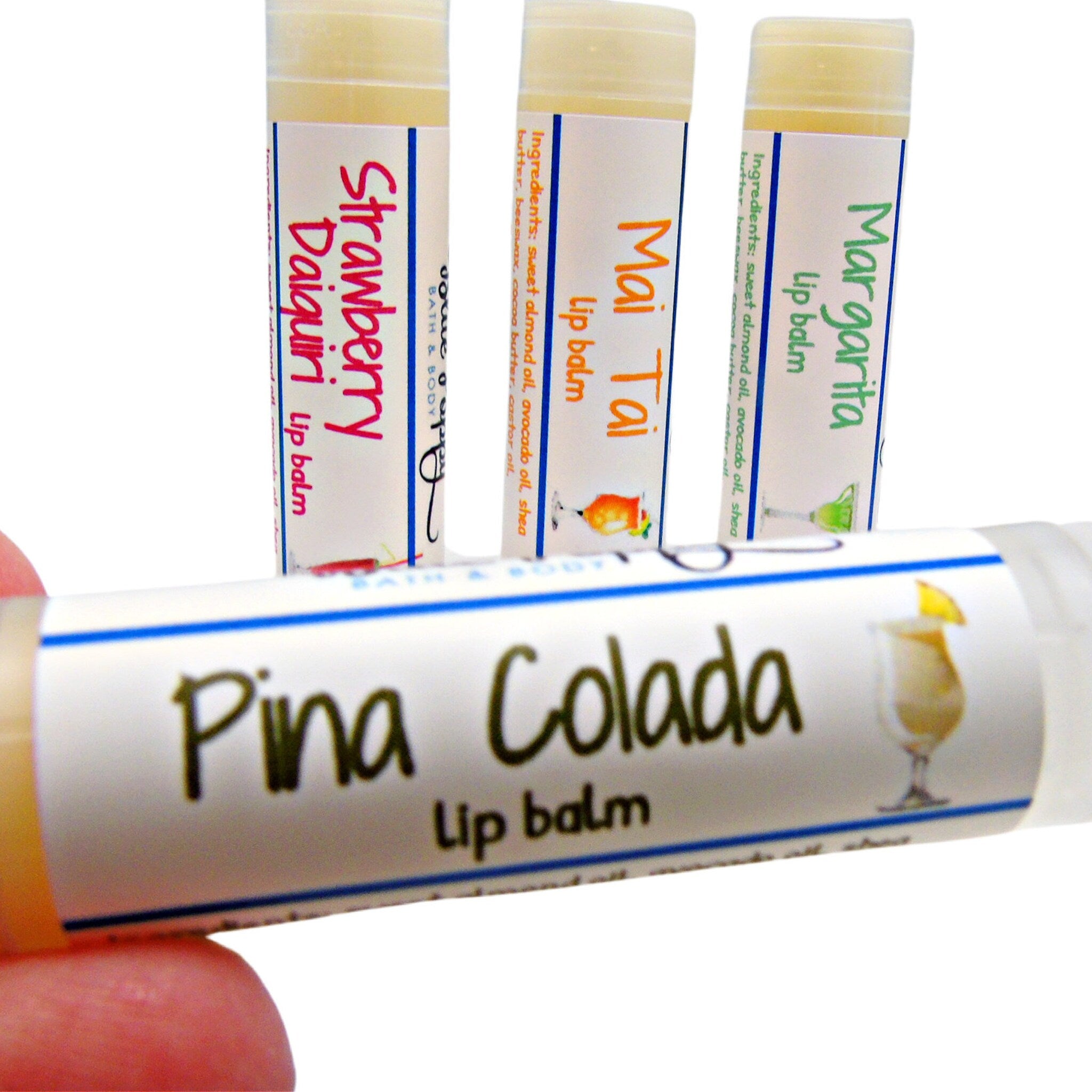 Lip balm tubes with white labels, colorful text, and drink illustrations